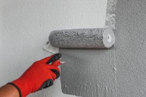Grey paint with worker painting wall